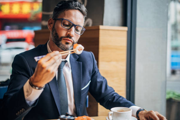 istock Man eating sushi in the restaurant 1175659831