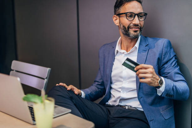 istock Man with credit card in cafe 1175660485