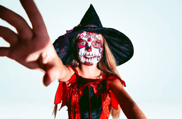 istock Little girl like a witch on white background 1175662238
