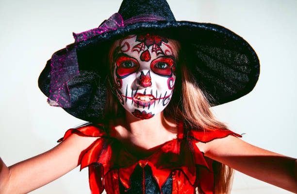 istock Little girl like a witch on white background 1175662470