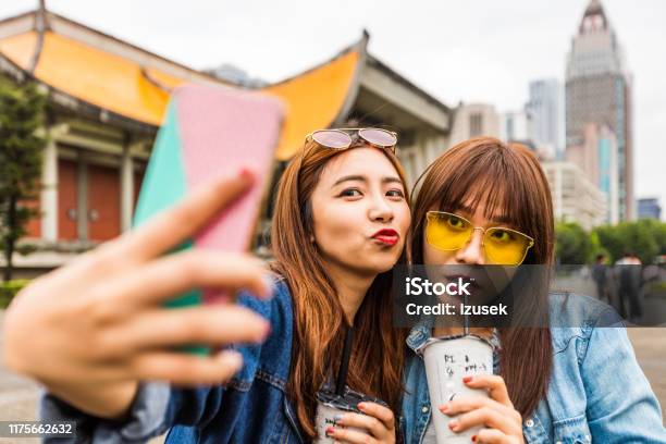 Female Friends Taking Selfie With Smart Phone Stock Photo - Download Image Now - 20-24 Years, Adult, Adults Only