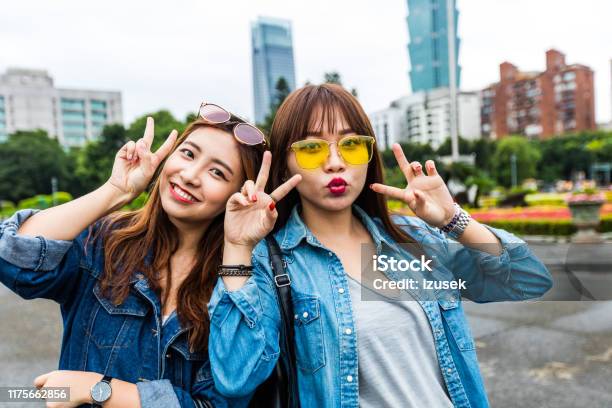 Portrait Of Happy Friends Gesturing In City Stock Photo - Download Image Now - Outdoors, 20-24 Years, Adult