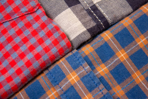 Freshly ironed shirts folded neatly and placed over one another.