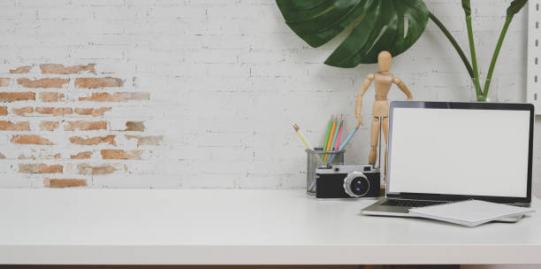 istock Minimal designer workplace with camera and office supplies on white table 1175663576
