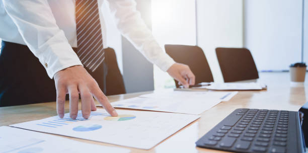 istock Young hard-working businessman analysing his investment plan with charts 1175664366