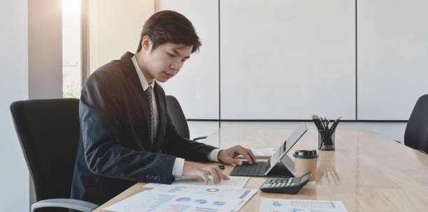 istock Male accountant compiling and analysing financial information to his client 1175664379
