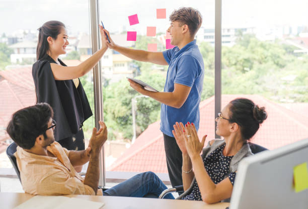 istock Group of young multiethnic diverse people gesture hand high five, laughing and smiling together in brainstorm meeting at office. Casual business with startup teamwork community celebration concept 1175664456