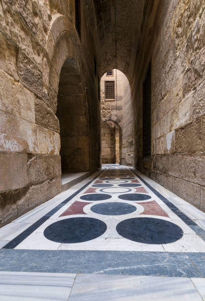 passaggio a volta che conduce al cortile della moschea del sultano qalawun con pavimento in marmo colorato, il cairo - courtyard arch arabic style cairo foto e immagini stock