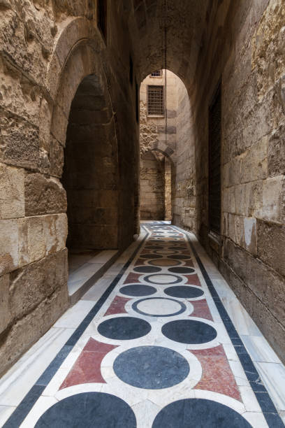 passaggio a volta che conduce al cortile della moschea del sultano qalawun con pavimento in marmo colorato, il cairo - courtyard arch arabic style cairo foto e immagini stock