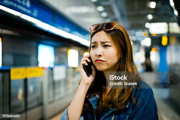 Displeased Woman Talking On Smart Phone Stock Photo - Download Image Now - 20-24 Years, Adult, Adults Only