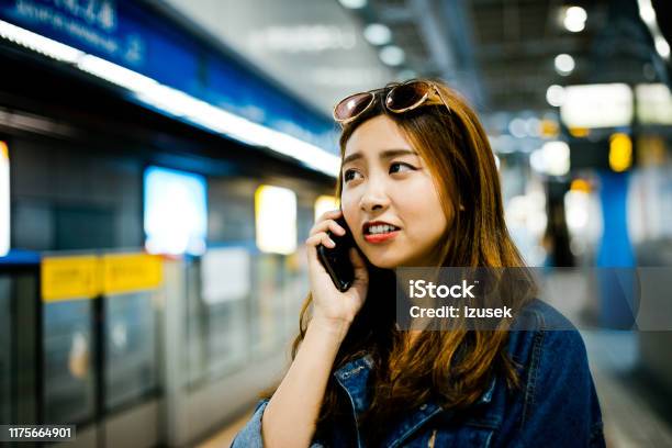 Female Looking Away While Talking On Smart Phone Stock Photo - Download Image Now - 20-24 Years, Adult, Adults Only