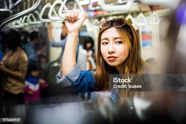 Female Passenger Traveling In Subway Train Stock Photo - Download Image Now - Asian and Indian Ethnicities, Females, Front View