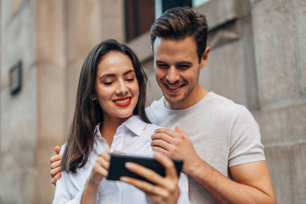 istock Couple standing outdoors and making selfie 1175666429