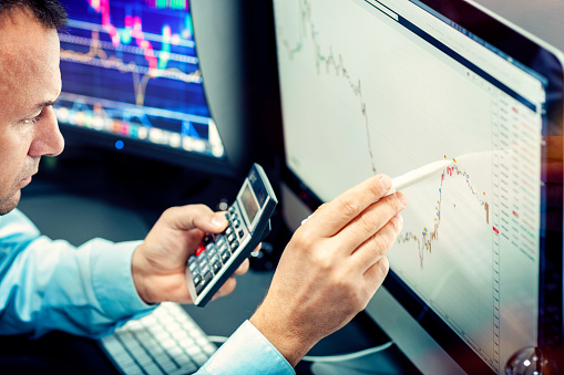 Stockbroker analyzes the financial chart. Online stock exchange on a computer monitor.