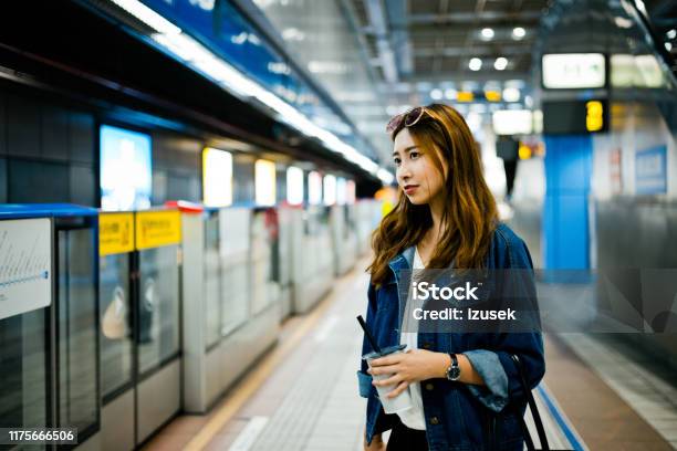 Thoughtful Woman Standing At Subway Station Stock Photo - Download Image Now - 20-24 Years, Adult, Adults Only