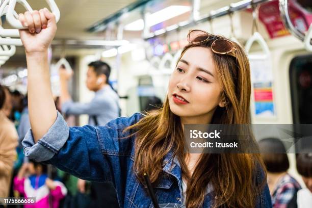 Young Woman Looking Away In Subway Train Stock Photo - Download Image Now - 20-24 Years, Adult, Adults Only