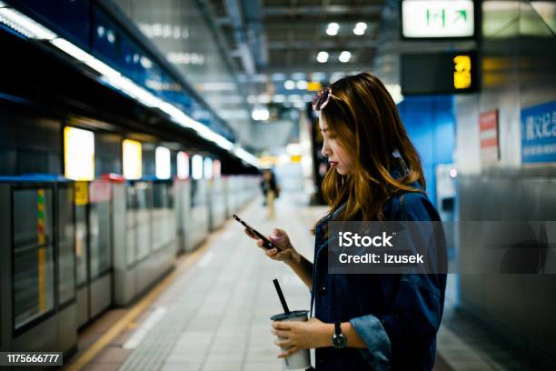 Young Woman Using Smart Phone At Subway Station Stock Photo - Download Image Now - 20-24 Years, Adult, Adults Only
