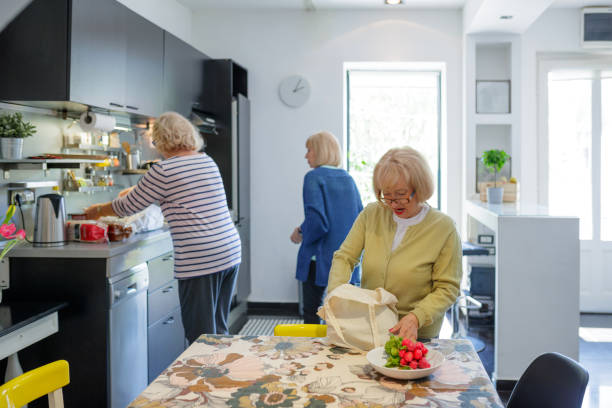 istock Senior woman taking a bunch of radish out on kitchen table 1175668263