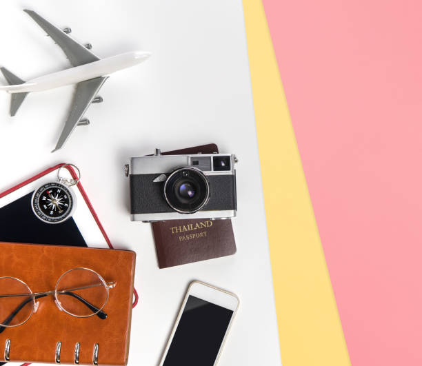 istock travel Vacation objects and accessories on white yellow pink background with passport camera and plane table for Vacation travel journey banner and poster concept 1175668942