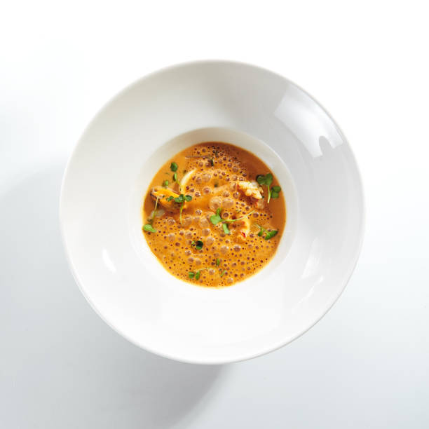 Russian Fish Soup with Radish and Tomato served in bowl top view of healthy dish