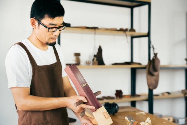 istock Asian carpenter working in the carpenter workshop. 1175669884
