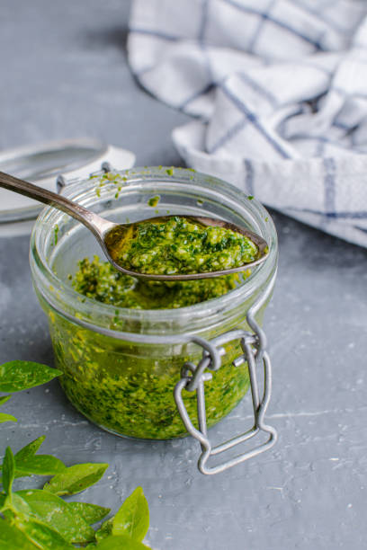 istock Glass jar with pesto sauce, top view 1175671565