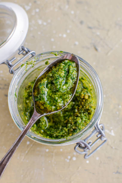 istock Glass jar with pesto sauce, top view 1175671571