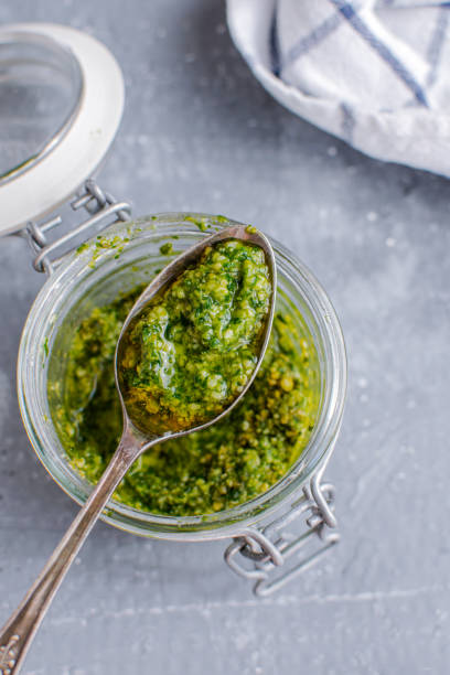 istock Glass jar with pesto sauce, top view 1175671672