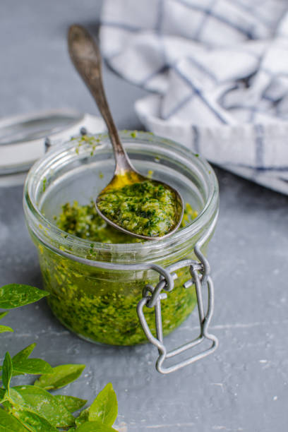 istock Glass jar with pesto sauce, top view 1175671681