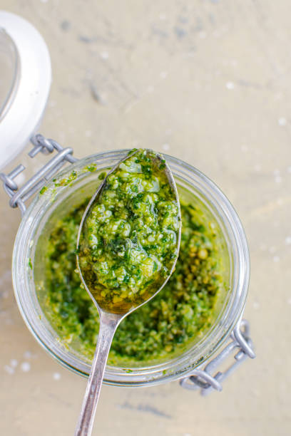 istock Glass jar with pesto sauce, top view 1175671739
