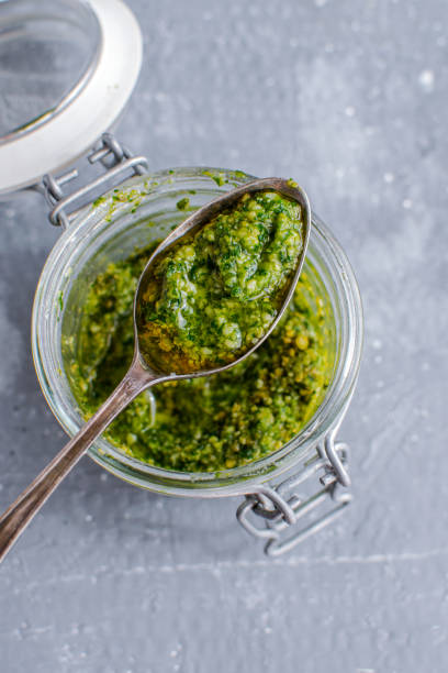 istock Glass jar with pesto sauce, top view 1175671787