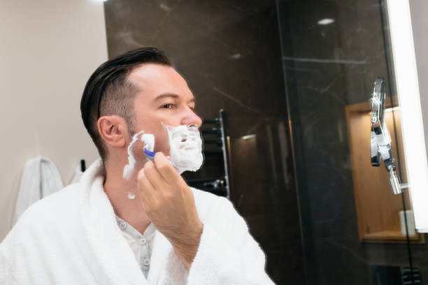 istock Man shaving with razor in the bathroom. 1175671985