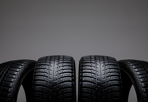 Studio shot of a set of four black car tires