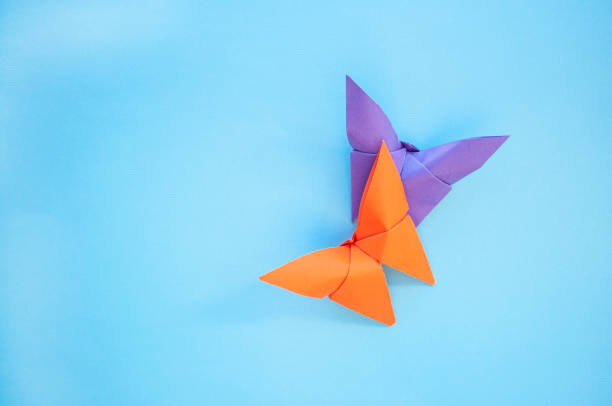 istock Origami paper butterflies on blue background. 1175673051