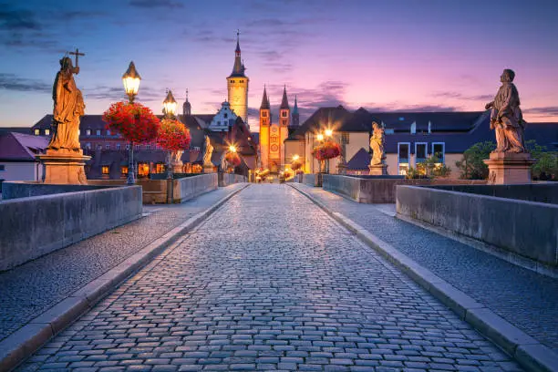 Cityscape image of the old town of Wurzburg with Old Main Bridge over Main river during beautiful sunrise.