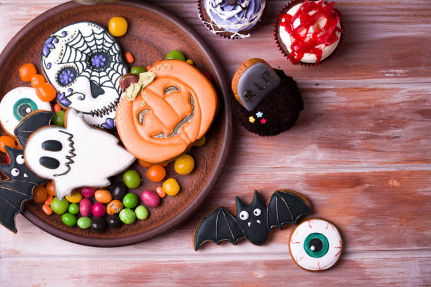 istock Halloween party content. Halloween gingerbread cookies on a wood background. 1175673242