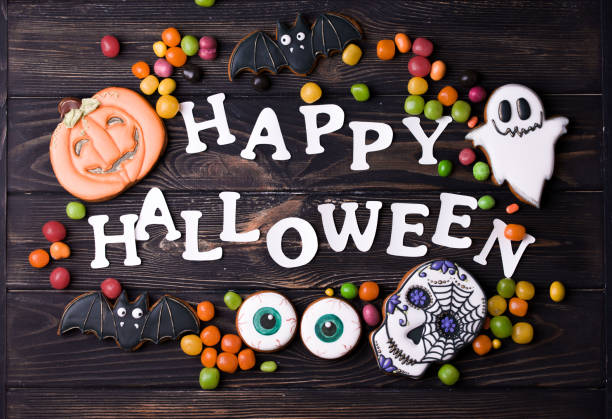 istock Halloween party content. White halloween inscription with small colored sweets. 1175673243