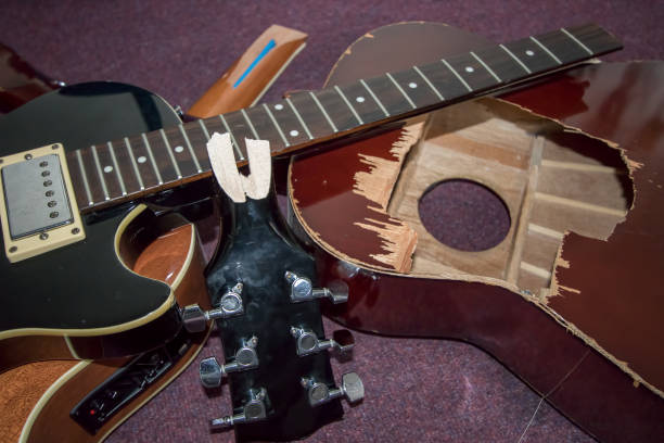 istock Broken guitar. Pile of smashed electric and acoustic guitars 1175674680