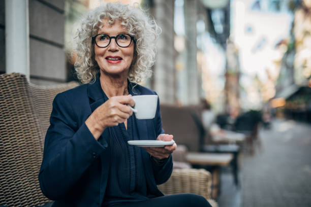 istock Beautiful senior woman drinking a hot drink 1175675365