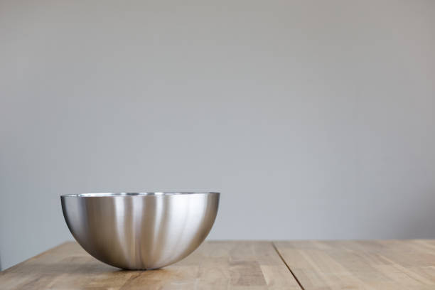 Empty metal salad bowl on the table. stock photo