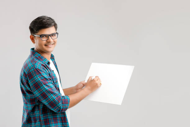 istock Indian/Asian Young Man showing blank signboard on White background 1175676982