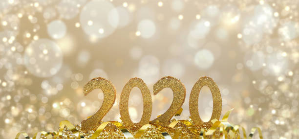 istock 2020 golden figures in glitter and on blur light background 1175678905