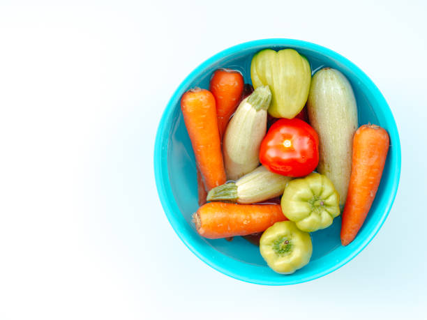 istock Blue bowl with vegetables inside isolated on white color studio background with copy space. Flat lay, view from top. 1175679066