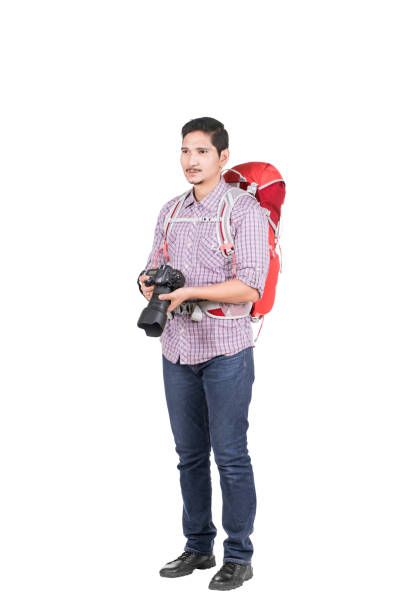 istock Asian man with a backpack holding a camera to take pictures 1175679227
