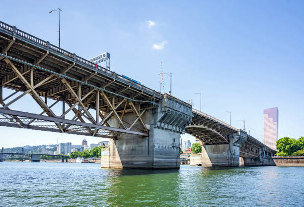 istock Buscle Burnside Bridge with big support columns and truss roadbed across Willamette River in Portland Oregon 1175679260