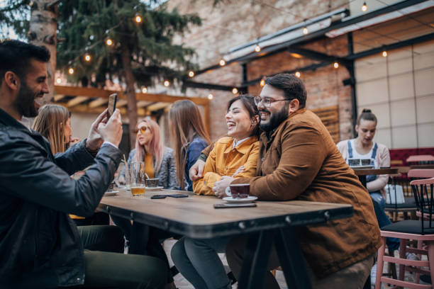 istock Friends sitting in sidewalk cafe 1175679261