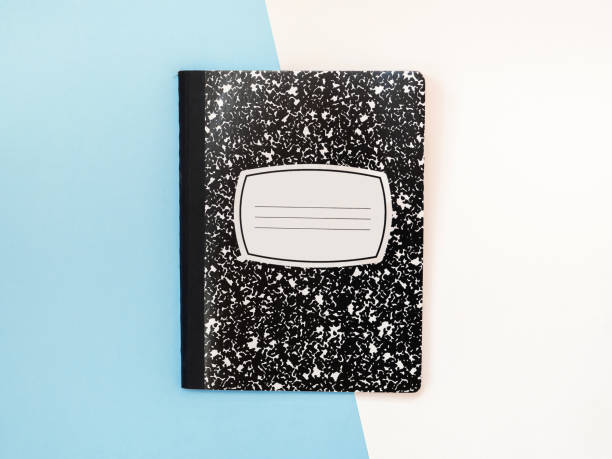 Black and white notebook isolated on dual white blue color studio background