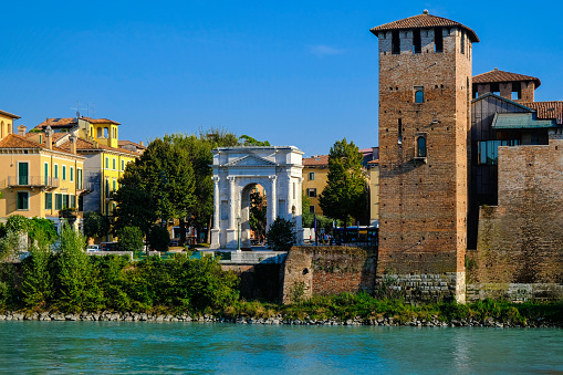 Verona, Italy: View on embankment of Adige river with ancient roman arch Arco dei Gavi