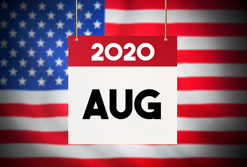 Calendar standing in front of the American flag and showing August 2020 Stock Image