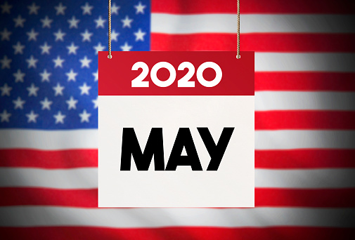 Calendar standing in front of the American flag and showing May 2020 Stock Image
